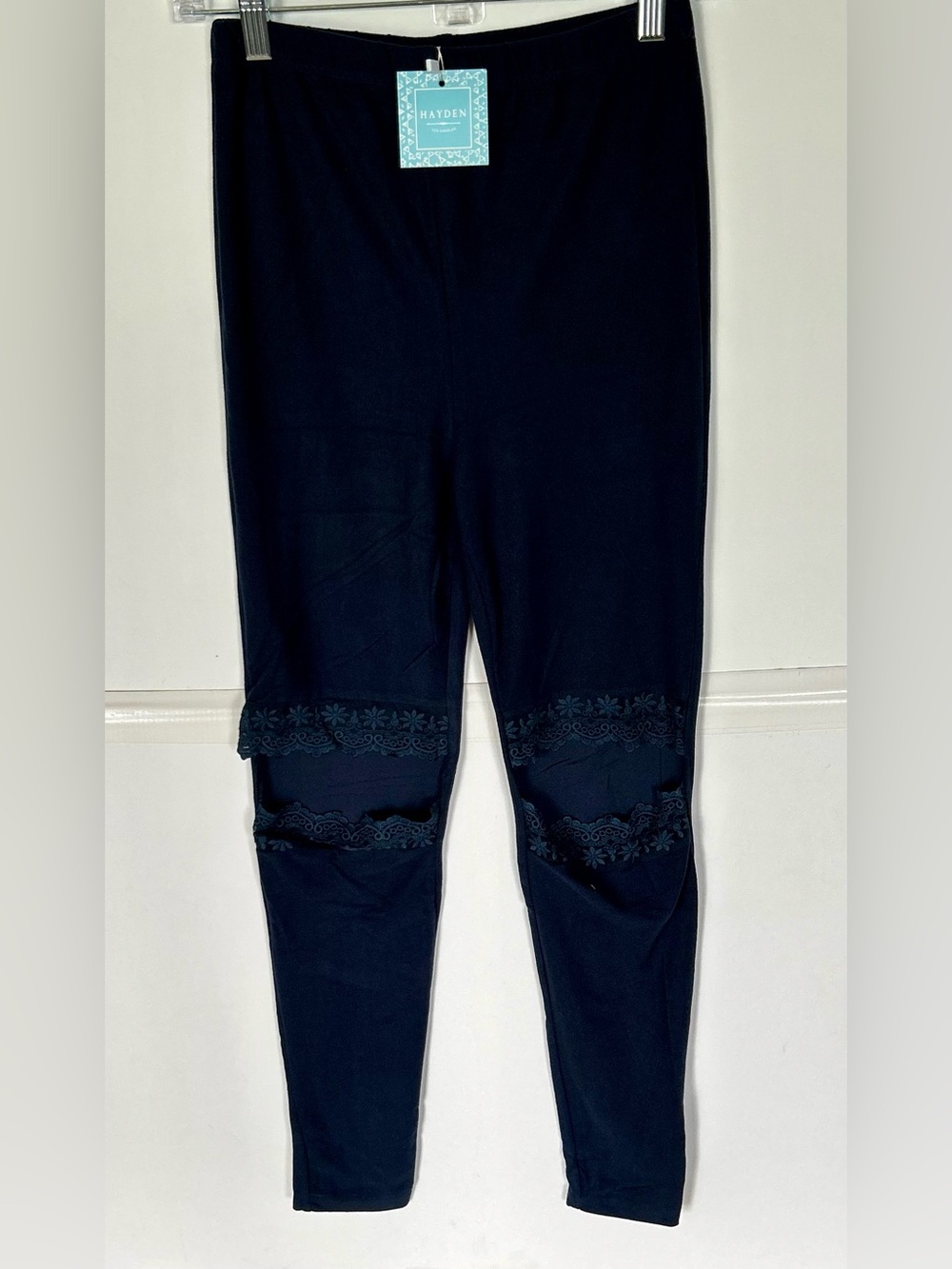 Hayden woman’s navy blue leggings with lace lined cutouts at knees. Size M